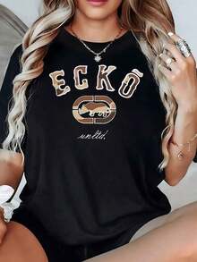 Figura central de rinoceronte en tonos tierra que simboliza fuerza y protección acompa? de letras grandes y modernas camiseta de mujer 100% algodón 220g - Negro - Ver 2