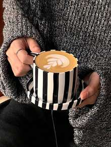 One Black Ceramic Cup and Saucer Set