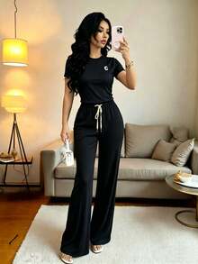el mejor regalo para el Día de la Madre:Conjunto deportivo de mujer con top corto de manga corta y pantalones acampanados con cintura anudada, para primavera/otoño - Negro - Ver 1