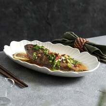 Este plato de pescado está disponible en múltiples tamaños y presenta exquisitos bordes ondulados de vieira y contornos de hojas, lo que le aporta un toque de elegancia moderna a tu mesa de comedor. El acabado blanco clásico complementa cualquier decoración de cocina y es perfecto para servir pescado entero, mariscos o aperitivos. - Blanco - Ver 3
