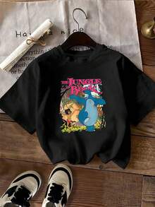 Vibrant Illustration Showing An Adventurous Boy And A Blue Bear Dancing In The Jungle, Symbolizing Freedom, Friendship, And Joy. Comfortable Casual Women's T-Shirt, Perfect For Everyday Wear. - 黑色 - 查看 2