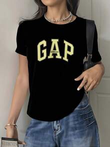 A Large Word That Conveys Strength And Confidence, With Yellow Letters That Evoke Positive Energy And A Modern Sporty Touch, Ideal For Reflecting An Active And Determined Attitude. A Comfortable, Casual Women's T-Shirt For Everyday Wear. - 黑色 - 查看 1
