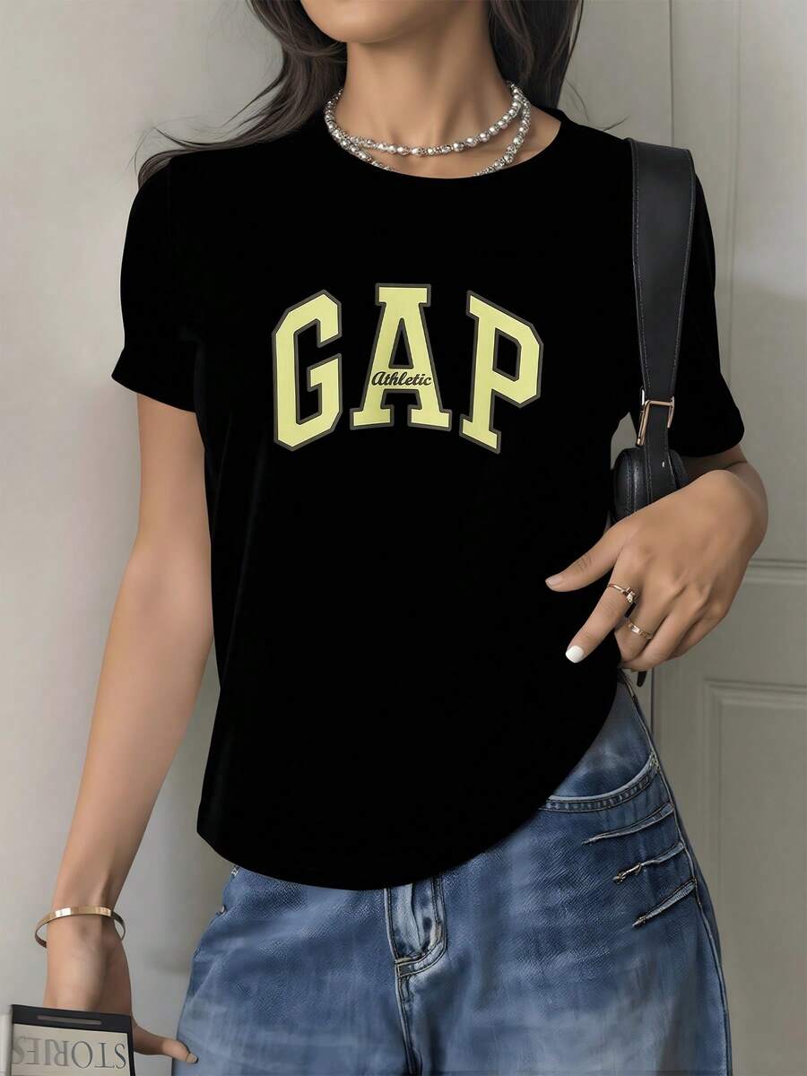 A Large Word That Conveys Strength And Confidence, With Yellow Letters That Evoke Positive Energy And A Modern Sporty Touch, Ideal For Reflecting An Active And Determined Attitude. A Comfortable, Casual Women's T-Shirt For Everyday Wear. - 黑色 - 查看 1