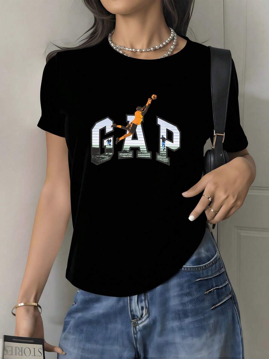 Vibrant Image Of A Football Player Leaping Powerfully Towards Victory, Highlighting The Passion And Drive To Achieve Dreams, Reflected In Large Letters Against An Urban Background. Modern Casual Women's T-Shirt, Ideal For Everyday Wear. - 黑色 - 查看 1