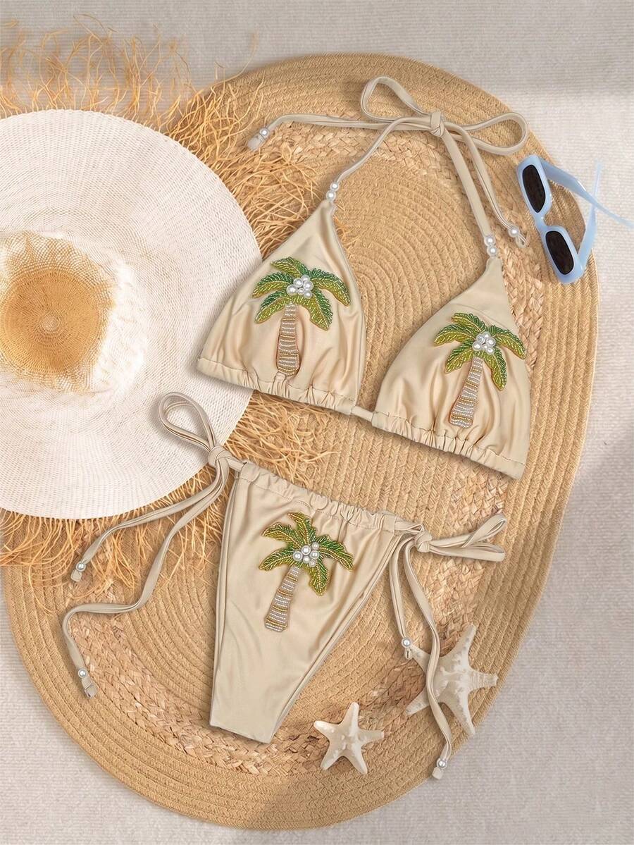 Bộ bikini hai mảnh màu mơ, kiểu dáng tam giác, cổ trễ, được trang trí bằng ngọc trai và thêu hình cây cọ, gợi cảm và thanh lịch, thích hợp cho nữ giới tham gia các hoạt động thư giãn mùa hè, đi biển, dự tiệc bể bơi. - Màu be - Xem 1