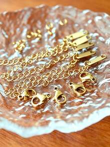 Conjunto de 25 Peças de Joalheria em Aço Inoxidável Dourado, Adequado para Criação de Colares e Pulseiras DIY - O Conjunto Completo Inclui 5 Fecho Tipo Lagosta, 5 Correntes de Extensão, 5 Pingentes e 10 Argolas de Suspensão - Design Anti-Desbotamento e À Prova d'Água, Perfeito para Joias Femininas Artesanais com Excelente Qualidade - Conjunto de corrente de extensão - Visão 1
