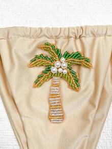 Bộ bikini hai mảnh màu mơ, kiểu dáng tam giác, cổ trễ, được trang trí bằng ngọc trai và thêu hình cây cọ, gợi cảm và thanh lịch, thích hợp cho nữ giới tham gia các hoạt động thư giãn mùa hè, đi biển, dự tiệc bể bơi. - Màu be - Xem 6
