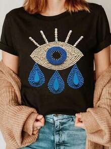 ‌Camiseta básica de manga corta para mujer Otoño/Invierno 2025: cuello redondo, corte holgado, estampado decorativo de ojos grandes de moda, tejido suave con caída perfecta y ultra combinable - Negro - Ver 1
