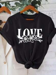 short-sleevePlayera minimalista moderna Plus Size - Plus Size - Un atuendo refrescante y dulce con un estampado floral de 'LOVE'. Esta camiseta casual de cuello redondo para mujeres de talla grande es perfecta para la primavera y el verano, ofreciendo un estilo creativo para salidas diarias. - Negro - Ver 6
