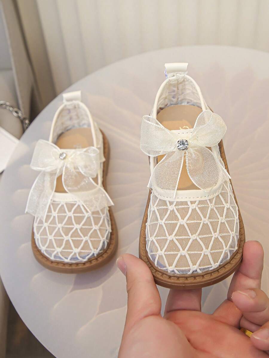 1 Pair Girls' Hollow Mesh Breathable Shoes, Decorated With Bows And Rhinestones, Soft Rubber Sole, Round Toe, Single Strap, Flat Heel, Sweet Princess Style Mary Jane Mesh Shoes, Suitable For Summer Daily Wear, School, Parties, Weddings, And Banquets - Beige - View 1