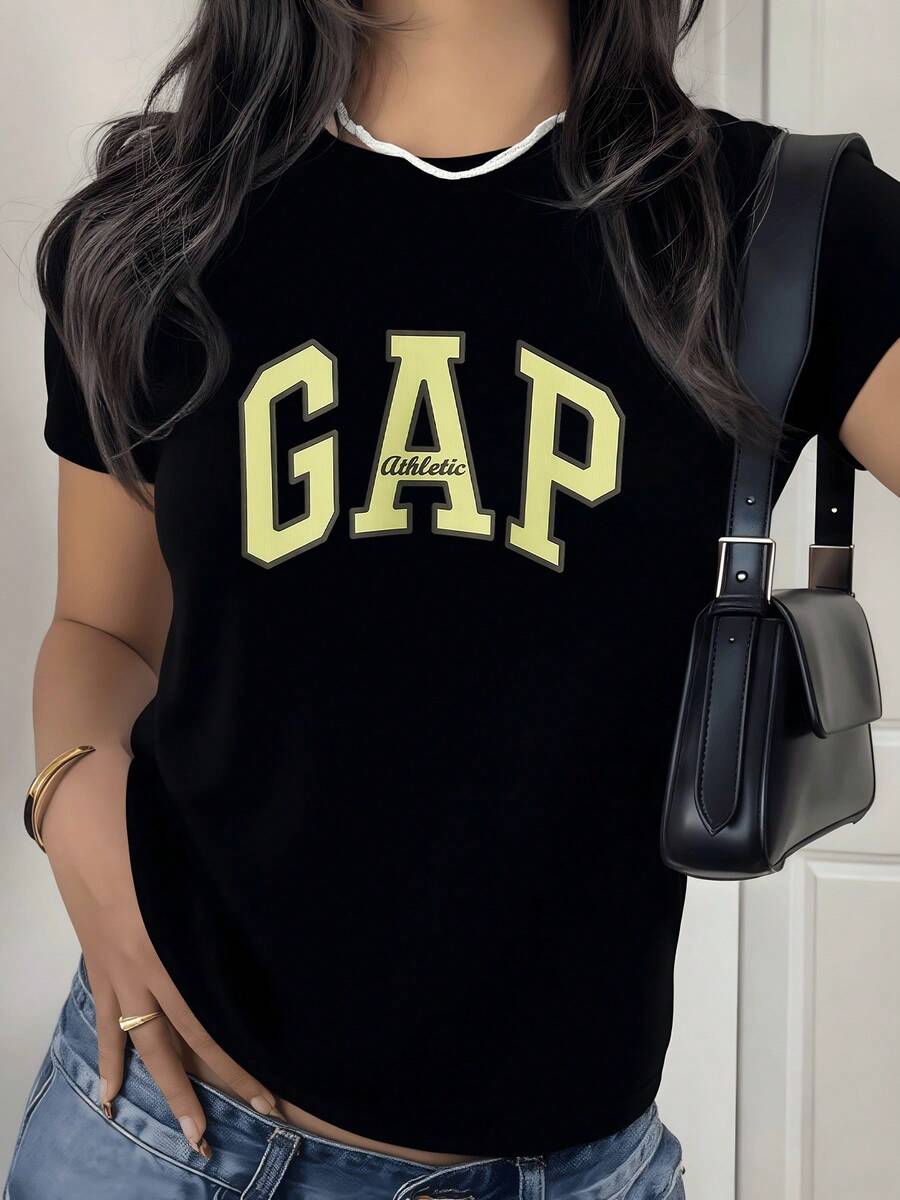 Large Letters In A Soft Yellow Tone Evoke Positive Energy And A Modern Sporty Attitude, Perfect For Conveying Confidence. Casual White Women's T-Shirt With An Attractive Print For Everyday Wear. - 黑色 - 查看 1