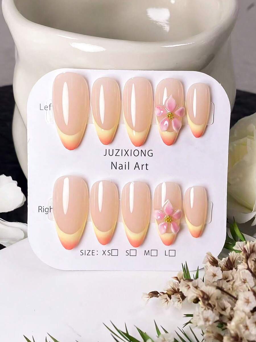 Bộ 10 móng giả thủ công hình hạnh nhân, kiểu chạm khắc hoàng hôn. Với lớp nền màu nude nhẹ nhàng, những móng giả này được thiết kế với các đường kẻ Pháp màu vàng vẽ tay và hiệu ứng chuyển màu cam, kết hợp với các họa tiết chạm khắc chuyển màu hồng thủ công. - Nhiều màu - Xem 1