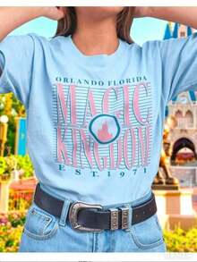 CHICLY19 Women's Oversized Graphic T-Shirt, 100% Cotton - White, Short Sleeve, With Retro Text "MAGIC KINGDOM", Castle Print And "ORLANDO FLORIDA EST." 1971 Design. Soft Cotton T-Shirt With A Relaxed Fit, Perfect For Theme Park Visits, Vacations, Family Trips, And Casual Everyday Wear. Popular Nostalgic T-Shirt With A Comfortable And Relaxed Fit, Ideal For Theme Park Fans, Travelers, And Vacationers. - 藍色 - 查看 10