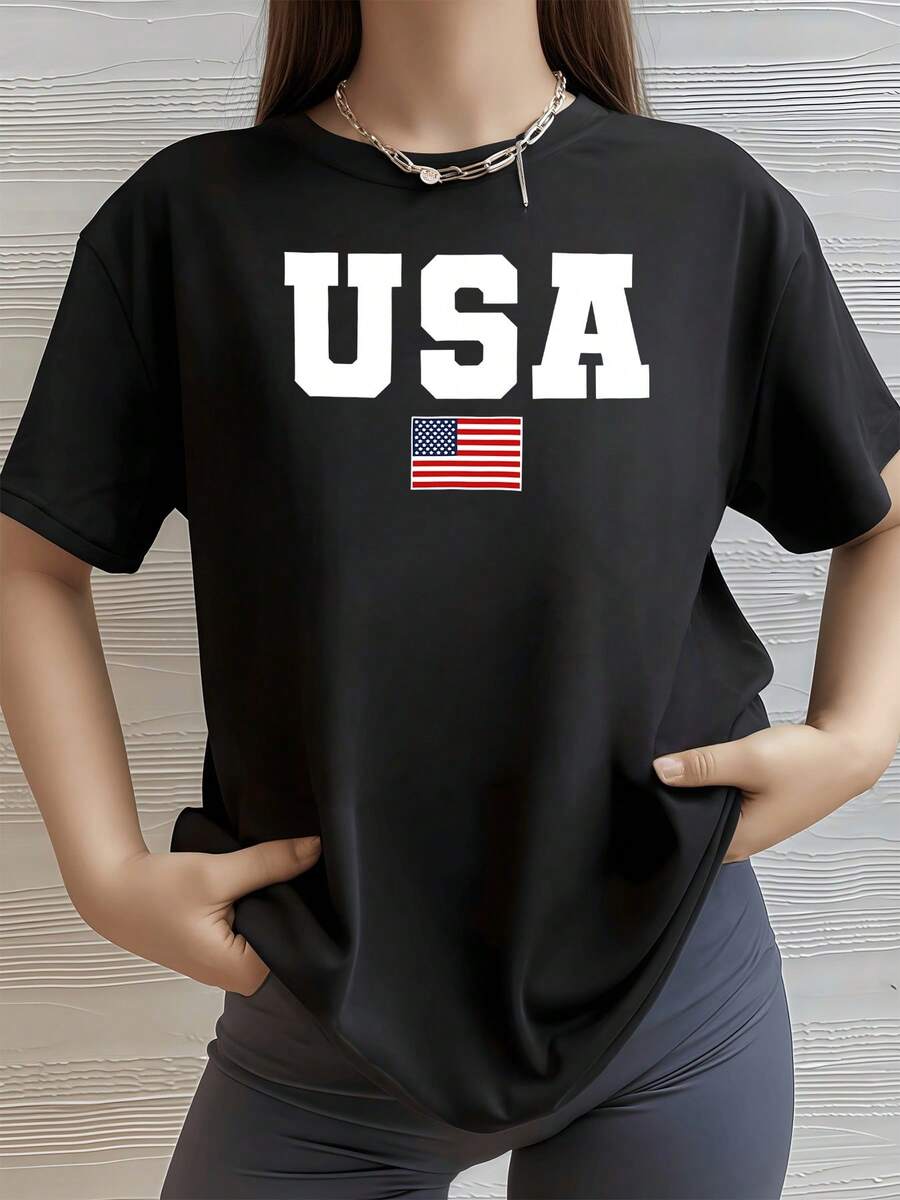 United States Flag With Large Letters Symbolizing National Pride, Freedom, And Unity. Perfect For Those Who Love American Energy. Women's Casual, Modern, Comfortable T-Shirt For Everyday Wear. - Black - View 1