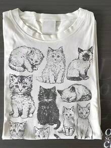 Camiseta de mujer, estampada con un diseño de un lindo gato vintage dibujado a mano, hecha de algodón puro, blanca, de manga corta, cuello redondo casual, corte regular. La tela es suave y agradable al tacto, cómoda y transpirable, adecuada para todas las estaciones. El color base blanco es versátil y elegante, llamativo y único, combinando fácilmente con diversos ambientes cotidianos. Solo una prenda superior, adecuada para atuendos de Año Nuevo y de San Valentín - Camiseta de manga corta de algodón holgada unisex de estilo vintage urbano con cuello redondo. blusas.blusas casuales para dama. - Blanco - Ver 6