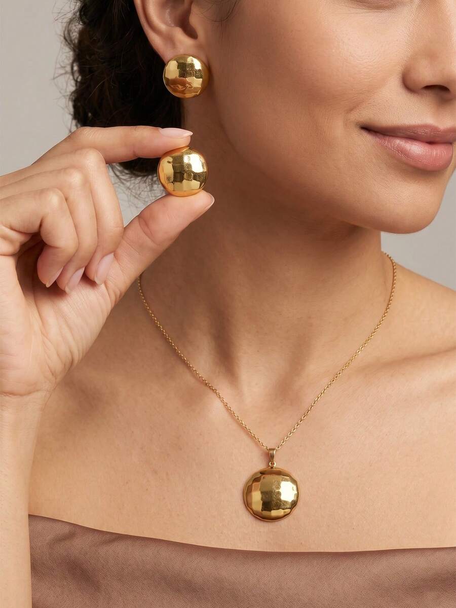 Bộ trang sức nữ thời trang gồm dây chuyền và bông tai hình tròn hình học mạ vàng, với họa tiết dập nổi độc đáo tạo nên hình dáng tròn đầy đặn, tối giản nhưng thanh lịch. Dây chuyền và bông tai mặt tròn có cùng thiết kế. Được làm từ thép không gỉ chất lượng cao, thân thiện với da và chống dị ứng, chống phai màu và oxy hóa. Bộ trang sức phối hợp này phù hợp với nhiều trang phục từ váy đến bikini, thích hợp cho đi làm, mặc hàng ngày và hẹn hò. Một lựa chọn tuyệt vời cho phụ kiện nữ và quà tặng dịp lễ.
