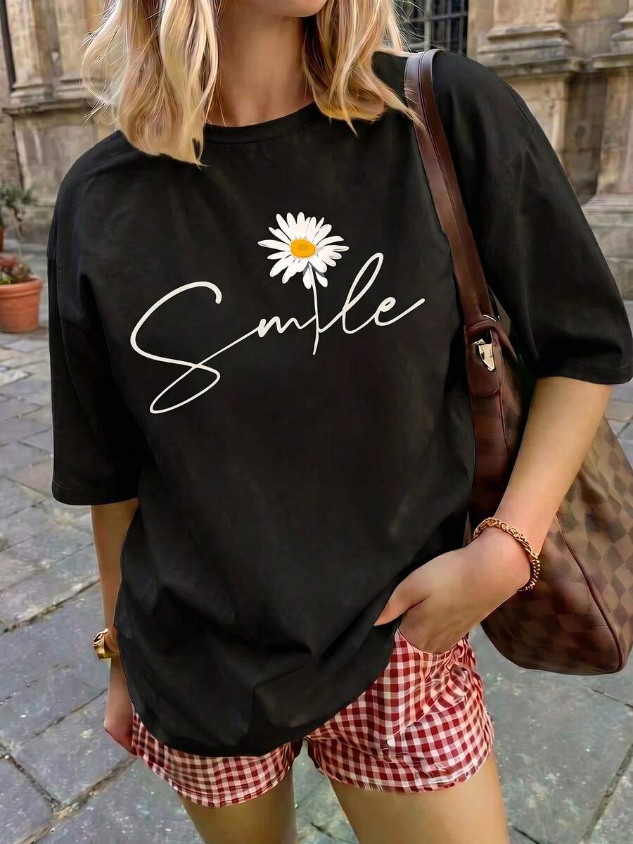 Camiseta informal de manga corta con cuello redondo y estampado de margaritas para mujer, de poliéster, de largo normal, ideal para conjuntos primaverales. - Negro - Ver 1