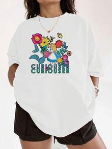 Colorful Illustration Of A Blonde Girl In A Blue Dress Surrounded By Vibrant Flowers Symbolizing Curiosity And Fantasy. Comfortable Casual Women's T-Shirt For Everyday Wear. - 白色 - 查看 6