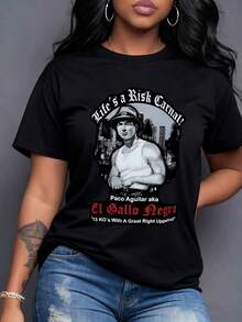 A Man In A Hat And Vest In A Cityscape With 'Life's A Risk, Carnal!' And The Name 'Paco Aguilar' With '13 KOs With A Great Right Uppercut' Symbolizes Courage, Strength, And Determination In The Face Of Challenges. This Is A Women's T-Shirt Ideal For Enhancing Your Bold Personality. 100% Cotton, Casual Short Sleeves. - 黑色 - 查看 1