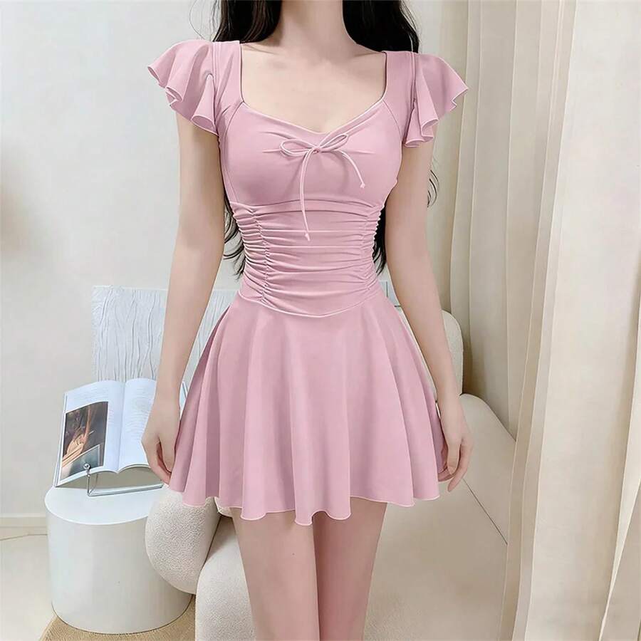 Traje de baño de mujer beige con estampado floral, cuello halter, diseño cruzado frontal, cintura fruncida y falda acampanada, ideal para verano y playa. - 09 - Ver 1