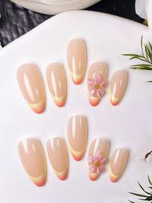 Bộ 10 móng giả thủ công hình hạnh nhân, kiểu chạm khắc hoàng hôn. Với lớp nền màu nude nhẹ nhàng, những móng giả này được thiết kế với các đường kẻ Pháp màu vàng vẽ tay và hiệu ứng chuyển màu cam, kết hợp với các họa tiết chạm khắc chuyển màu hồng thủ công. - Nhiều màu - Xem 4