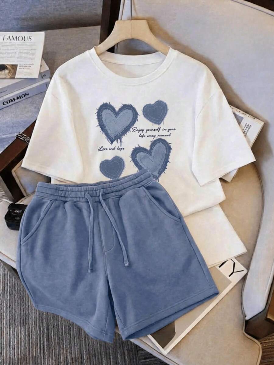 Una camiseta de manga corta para mujer con estilo retro americano, de diseño holgado y estampado (los pantalones son solo sugerencias de estilo). Este artículo sencillo y elegante presenta patrones de texto con temática tropical, siendo un elemento imprescindible para crear un estilo relajado de vacaciones. Es muy adecuado para ocasiones como el Día del Trabajo y el Día de la Independencia de México. La gruesa camiseta multicolor está hecha de 100% algodón con estampados modernos, y es adecuada tanto para hombres como para mujeres. Es un estilo completamente nuevo para primavera/verano/otoño, transpirable y cómodo, sencillo y versátil. - Blanco - Ver 1