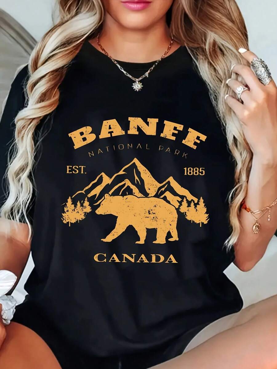 Camiseta para mujer del Parque Nacional Banff, Canadá - Camiseta con estampado de oso y montaña, adecuada para uso casual; camiseta de manga corta y cuello redondo con el icónico diseño de Banff, establecido en 1885, ideal para viajes al aire libre y ropa de recuerdo canadiense - [Negro] - Ver 1