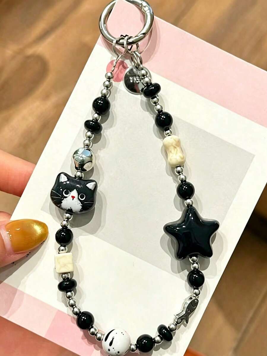 1个可爱别致的黑猫星星手机挂饰,配有透明垫,采用3D猫咪造型设计,搭配亮黑色星星,融合骨银饰品元素,营造奢华高端的视觉效果。方便携带,适合户外使用,独特风格,百搭时尚。 - 彩色 - 查看 1
