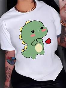Drawing Of A Small Green Dinosaur With Pink Cheeks Smiling While Holding A Red Heart Expressing Tenderness And Affection. Women's Casual, Modern, And Fun T-Shirt For Everyday Wear. - 白色 - 查看 1