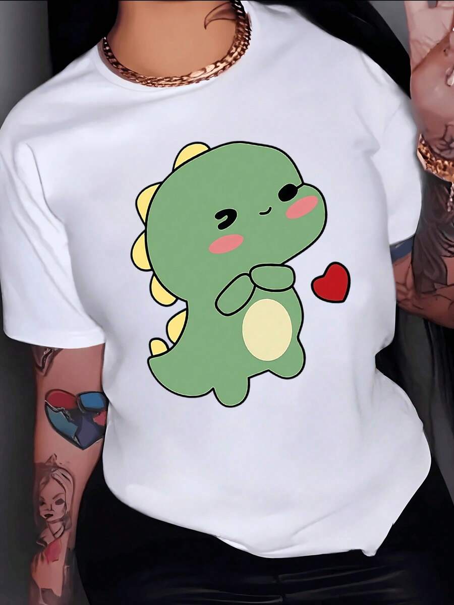 Drawing Of A Small Green Dinosaur With Pink Cheeks Smiling While Holding A Red Heart Expressing Tenderness And Affection. Women's Casual, Modern, And Fun T-Shirt For Everyday Wear. - 白色 - 查看 1