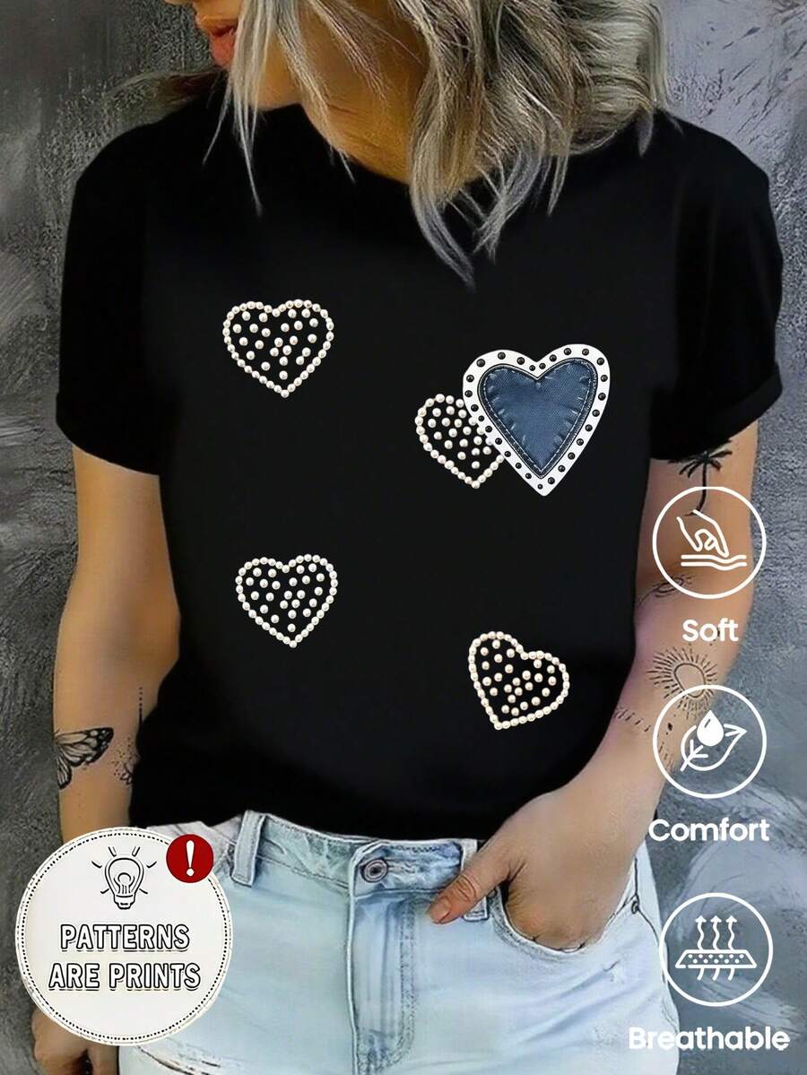 Esta camiseta de manga corta, cuello redondo y corte holgado para mujer es perfecta para el verano. Presenta un divertido estilo retro Y2K con un estampado de corazón en mezclilla con perlas sintéticas. Ideal para vacaciones, la oficina, salidas, el día a día, citas, fiestas, reuniones y estilo urbano. Esta versátil prenda deportiva informal también es un excelente regalo para diversas ocasiones. - Negro - Ver 1