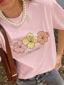 Camiseta de manga corta con cuello redondo elástico, estampado de hibisco y eslogan colorido, nuevo estilo de verano para mujer. Estilo retro suave, llamativo y cómodo, adecuado para el campus/ir al trabajo, reuniones de fin de semana, fiestas de verano en el patio, citas informales de verano. - Rosa - Ver 2