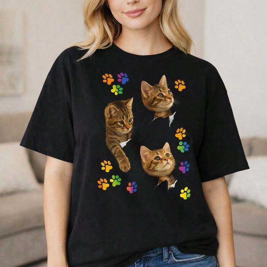 Camiseta de algodón casual para mujer, camiseta oversize con estampado de gatito en 3D y huellas de patas coloridas, top de manga corta de corte holgado para uso diario, camiseta básica suave y cómoda para amantes de los gatos. - Negro - Ver 1