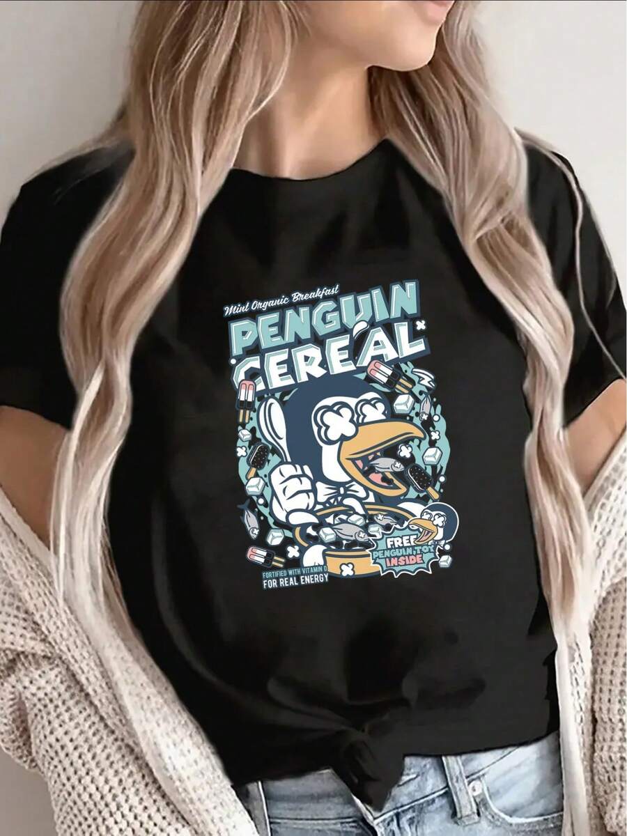 Camiseta con estampado de cereales de pingüino - Top de manga corta y cuello redondo| Camisa de poliéster lavable a máquina, con un llamativo diseño de pingüino y tazón de cereales.| Ropa adecuada para uso casual diario - Negro - Ver 1