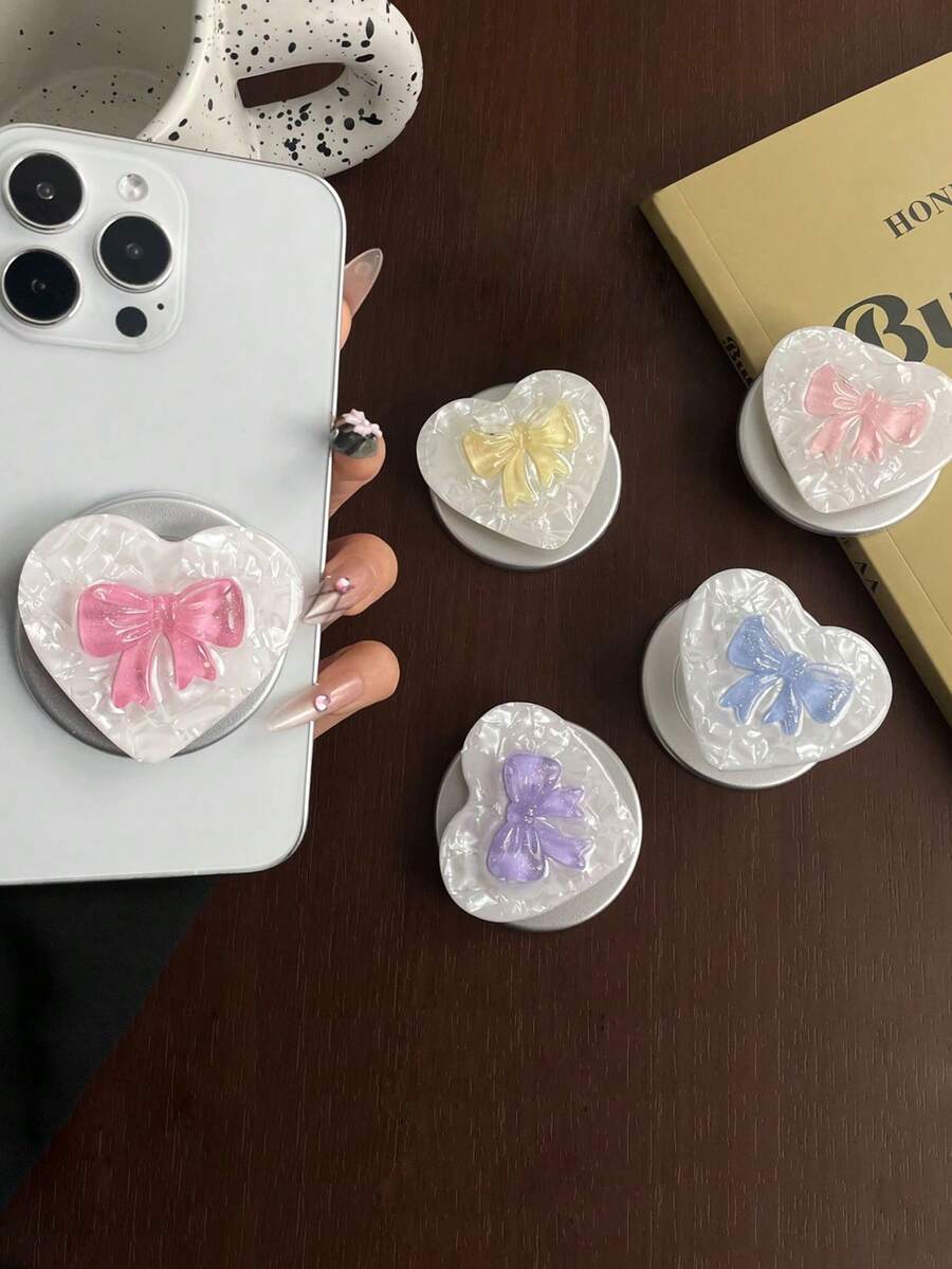 1个彩色果冻蝴蝶结磁吸弹出式支架——可伸缩、可折叠、便携的桌面支架,兼容苹果和安卓手机。它配有底座和磁环,可搭配任何手机壳使用。是送给女孩生日、节日或周年纪念日的理想礼物。 - 彩色 - 查看 1