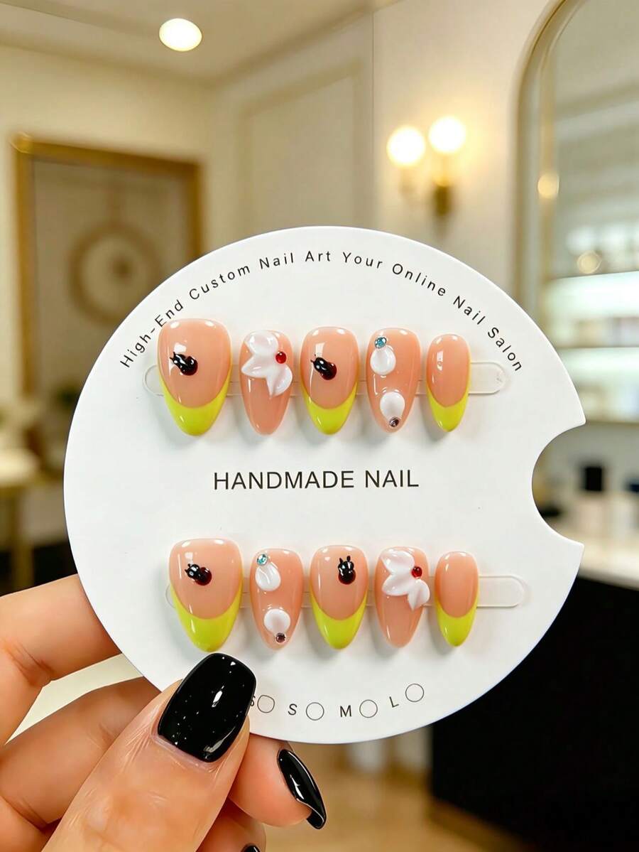 10 Pieces Of Hand-Made Almond-Shaped Press-On False Nails In A Vibrant And Playful Style. With A Sheer Nude Base, They Feature Hand-Painted French Tips In Lemon Yellow, Paired With 3D Black Ladybugs And White Petals. Cute And Lovely, They Are A Must-Have For Sweet Girls And Come With A Tool Kit. Handmade Press On Nails - Yellow - View 1