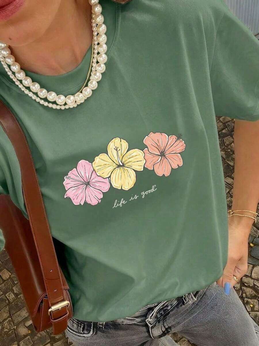 Camiseta de manga corta con cuello redondo elástico, estampado de hibisco y eslogan colorido, nuevo estilo de verano para mujer. Estilo retro suave, llamativo y cómodo, adecuado para el campus/ir al trabajo, reuniones de fin de semana, fiestas de verano en el patio, citas informales de verano. - Verde Oliva - Ver 1