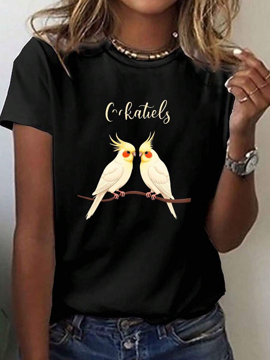 Camiseta de mujer: Una camiseta casual de manga corta y cuello redondo con un diseño de dos loros mirándose el uno al otro, perfecta para que las mujeres la usen en verano y primavera. - Negro - Ver 1