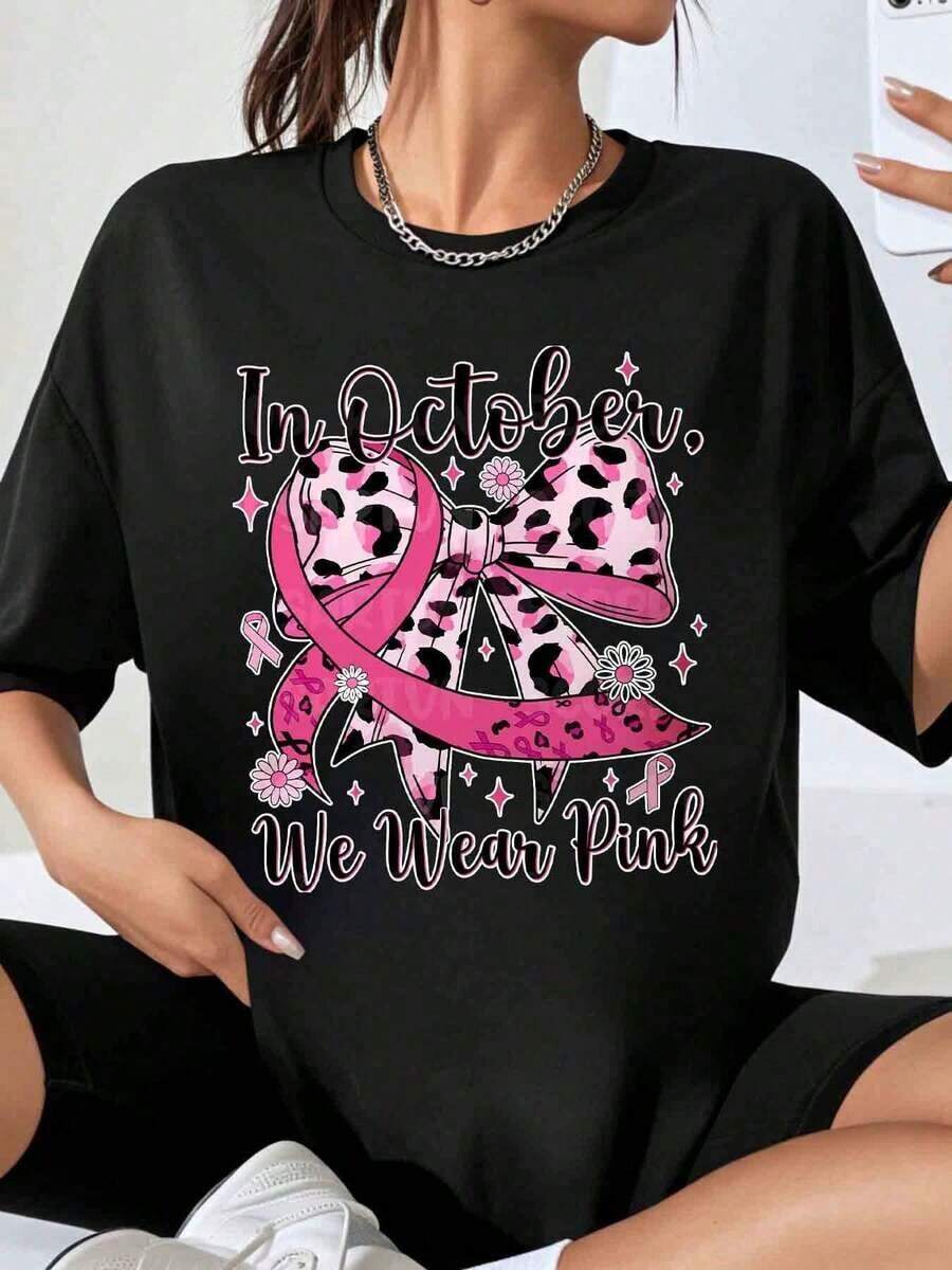 In October We Wear Pink Breast Cancer Awareness T-Shirts With A Leopard Print Ribbon And Bow Design For Women, A Fashionable Garment That Expresses Support For Breast Cancer, Ideal As A Gift For October Awareness Month. - Black - View 1