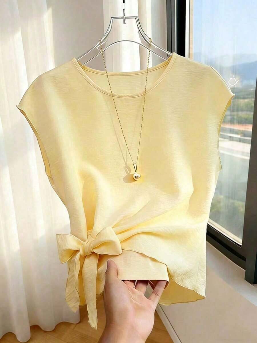 Blusa casual y versátil de cuello redondo elegante, con detalle de lazo en el bajo asimétrico, blusa de mujer de manga corta color albaricoque - Amarillo claro - Ver 1