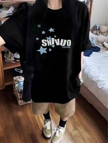 Camiseta gráfica 'SUNWO' para mujer - Camiseta negra de manga corta con estampado de estrellas, estilo casual y elegante, ajuste relajado para primavera/verano, ropa casual de verano |   Camiseta ajuste relajado |   Ajuste cómodo - Negro - Ver 1
