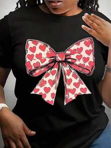 Soft, Breathable, And Lightweight For All-Day Comfort. Valentine's Day T-Shirt With A Heart Bow. Classic Crew Neck With A Relaxed Fit That Flatters All Body Types And Is Easy To Pair With Jeans, Shorts, And Leggings. - 黑色 - 查看 1