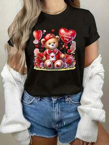 [Camiseta Teddy Heart] Camiseta de Mujer para el Día de San Valentín con Estampado de Oso de Peluche y Corazón - Top Casual de Cuello Redondo Suave con Diseño Adorable de Oso y Corazón, Blusa Lavable a Máquina para Atuendo Casual de Primavera, Verano, Otoño o Regalo de San Valentín, Tela Cómoda - Estilo Vintage Urbano Unisex, Camiseta de Manga Corta de Algodón Holgada con Cuello Redondo. blusas.blusas casuales para dama.Impresión de osos cariñosos.Camiseta estampada Impresión de osos cariñosos. - Negro - Ver 1