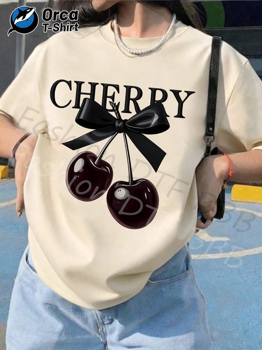 Esta camiseta de manga corta informal para mujer, ideal para las vacaciones de verano, presenta un lazo negro brillante y un estampado de cerezas, está hecha de 100% tela y pesa 6.35 onzas. Es un producto de la marca Orca, que encarna el estilo Y2K, y es perfecta para salidas de ocio en verano, aventuras al aire libre, vacaciones o como un regalo considerado. - Albaricoque - Ver 1