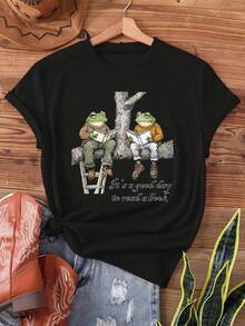 Suave [Ropa de Maternidad] Dos ranas están leyendo un libro en un tronco de árbol; hoy es un gran día para leer los interesantes libros de Rana y Sapo. Camiseta estampada, top casual de manga corta y cuello redondo, adecuada para verano y primavera, ropa de mujer, blusas elegantes para damas. - Negro - Ver 7