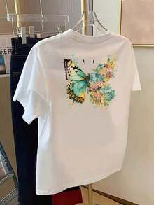 Under The RadarCamiseta estampada por delante y por detrás, con diseño de mariposas y flores, patrón de belleza natural, cuello redondo, manga corta informal para mujer, ajuste cómodo, diseño clásico, artículo de moda, top estampado de doble cara para mujer 2026. Camiseta unisex de algodón holgada de manga corta y cuello redondo estilo vintage urbano - Blanco - Ver 2