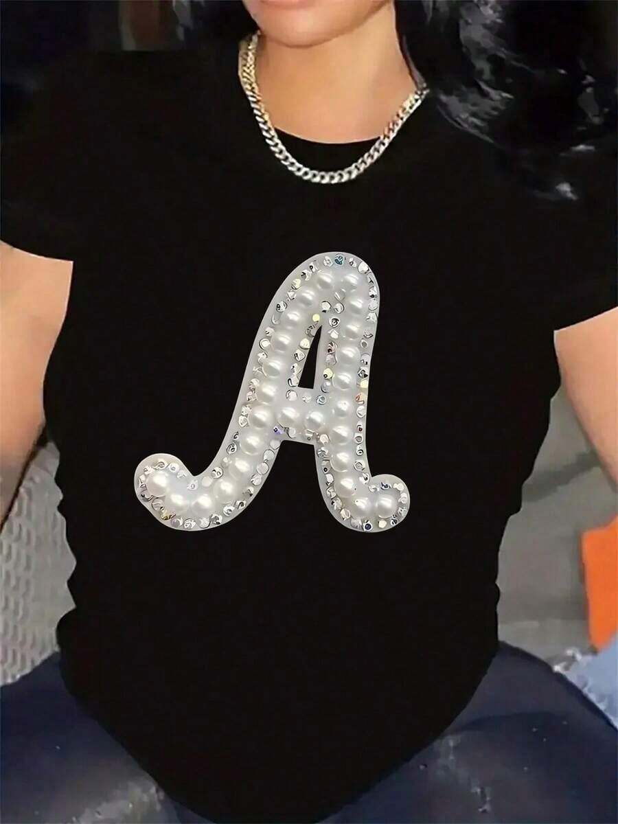 Suave, transpirable y ligera para comodidad durante todo el día. Camiseta de manga corta con letra A adornada con perlas, de tela de poliéster, ligera y duradera, perfecta para uso casual en restaurantes o salas de estar. Cuello redondo clásico con un corte relajado que favorece todas las formas del cuerpo y es fácil de combinar con jeans, shorts y leggings. - Negro - Ver 1