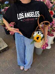Camiseta de manga corta para mujer, estilo casual de verano, con estampado de eslogan de Los Ángeles, holgada y versátil, con cuello redondo, ideal para uso diario y vacaciones. - Negro - Ver 6