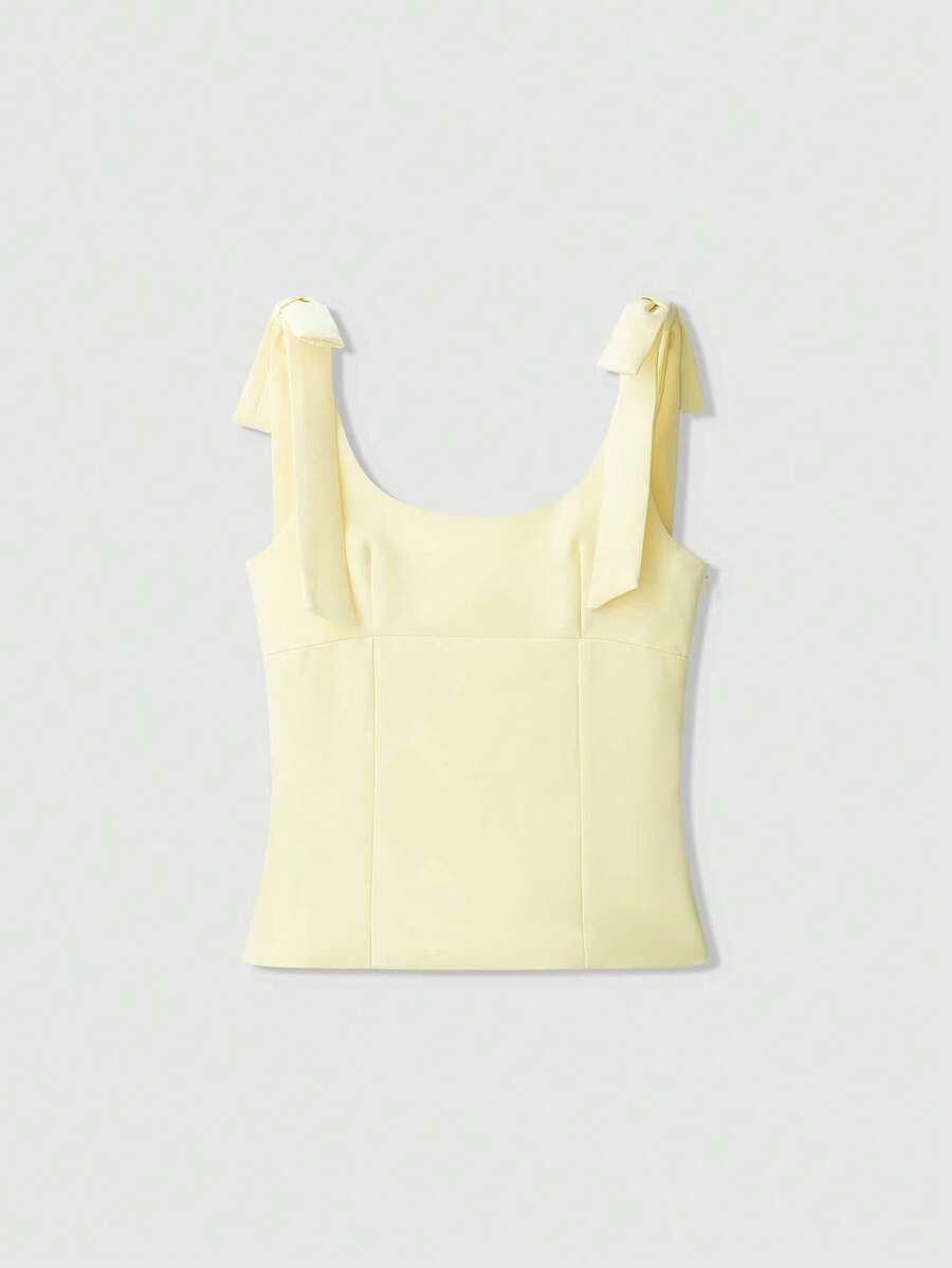 Top casual sin mangas con cuello redondo oversize en color amarillo mantequilla con decoración de lazo - Blanco y Negro - Ver 1