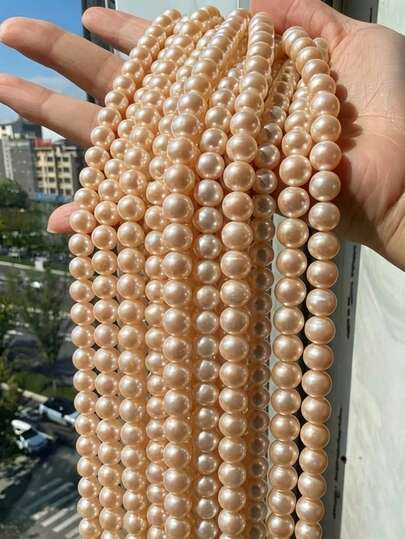 Hạt ngọc trai vỏ sò màu hồng hình tròn, dạng rời, dùng để làm trang sức, vòng cổ, vòng tay tự làm.
